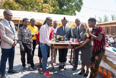 official hands over of tailoring material