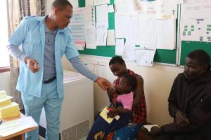 Health workers give two-dose oral regimen to a beneficiary