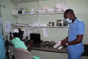Isaac prepares to provide care to a patient