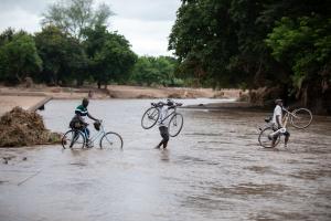 Cyclone Freddy victims in Chikwawa, Malawi, crossing the Namikalango River to seek shelter at a camp on the other side. 