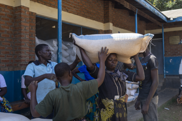 Beatrice Kumpondo and community members receiving food aid.