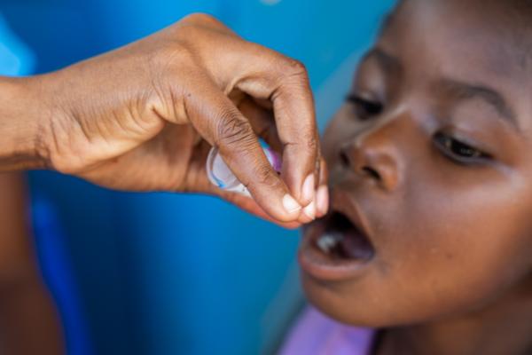 Baby taking the polio vaccine