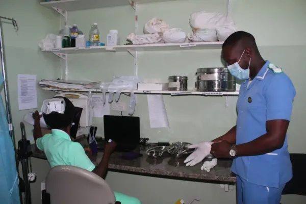 Isaac prepares to provide care to a patient