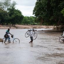Cyclone Freddy victims in Chikwawa, Malawi, crossing the Namikalango River to seek shelter at a camp on the other side. 