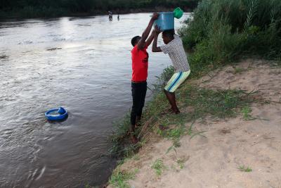 People fetching water in the Lisungwi River 