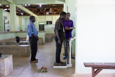 Timothy John stands on the scale during a routine check-up